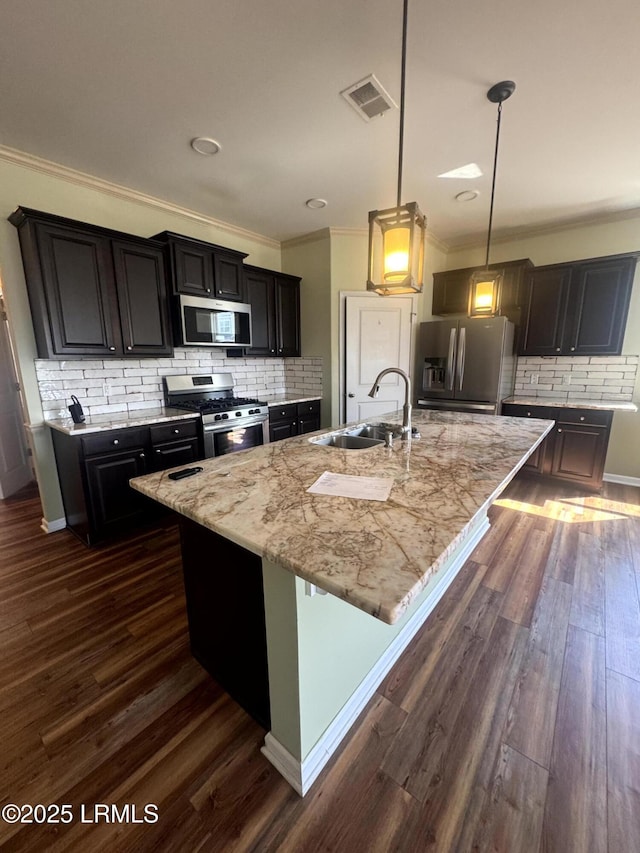 kitchen featuring a sink, visible vents, appliances with stainless steel finishes, and dark wood finished floors