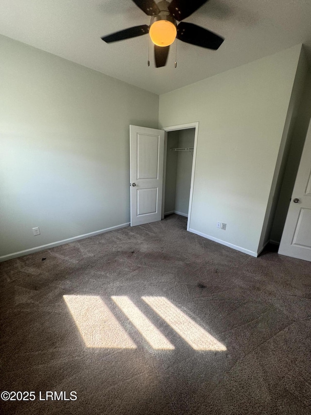 unfurnished bedroom featuring a ceiling fan, carpet, and baseboards