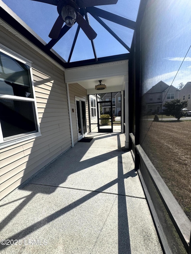 sunroom / solarium featuring ceiling fan