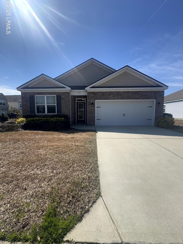 single story home featuring a garage, brick siding, and driveway