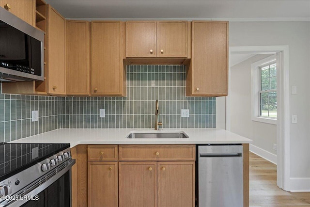1730 Battery Park Dr, Port Royal, SC 29935 - kitchen with stainless steel appliances, light wood-style floors, tasteful backsplash, light countertops, and crown molding