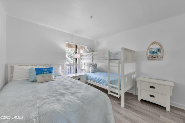 bedroom featuring light wood-type flooring and baseboards