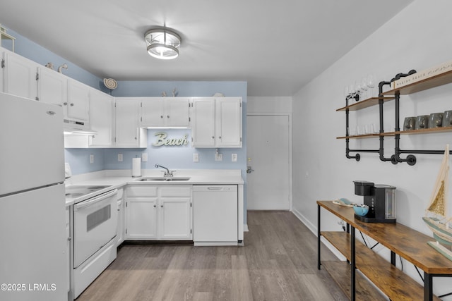 kitchen with light countertops, white cabinetry, a sink, white appliances, and under cabinet range hood