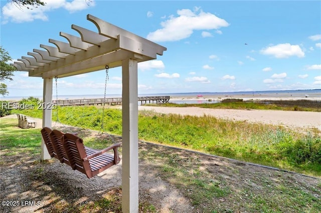 exterior space featuring a water view and a beach view