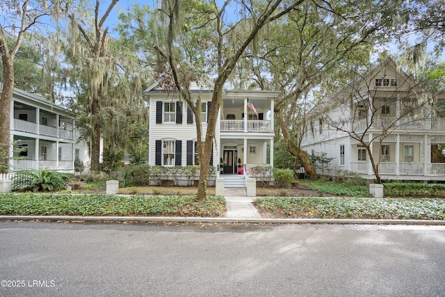 view of front facade with a balcony and covered porch