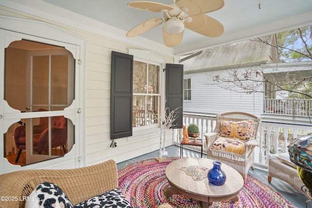 sunroom / solarium with a wealth of natural light and a ceiling fan