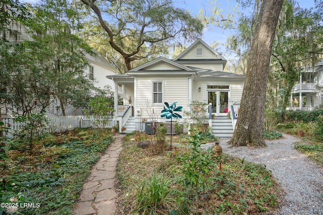 view of front of property featuring a porch, fence, and central air condition unit