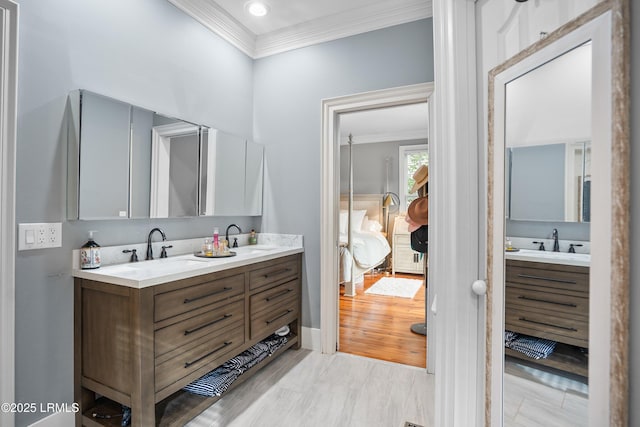 bathroom featuring ornamental molding, a sink, and double vanity