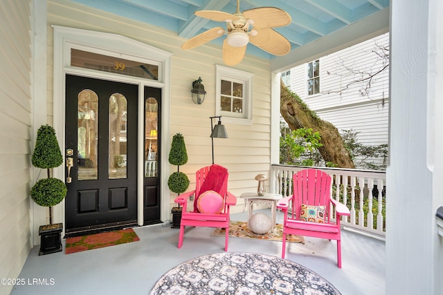 entrance to property with covered porch and a ceiling fan