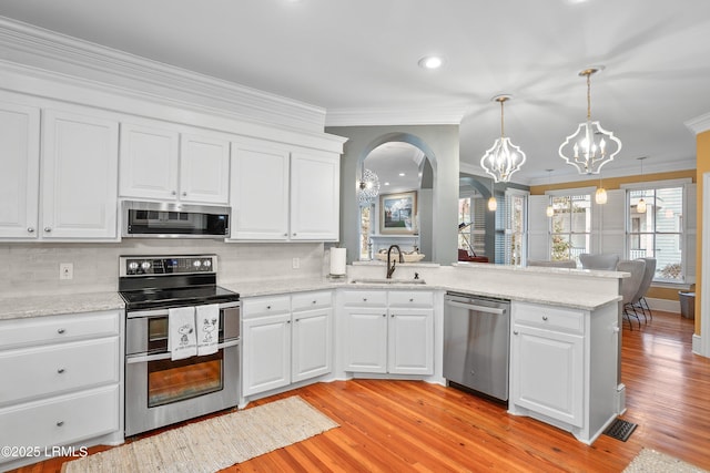 kitchen featuring white cabinetry, stainless steel appliances, and a sink