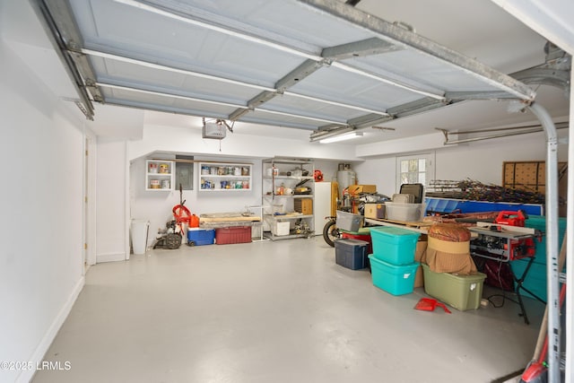 garage with baseboards and a garage door opener