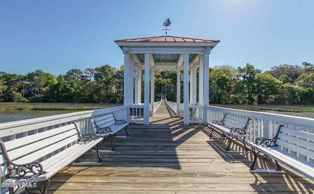 wooden terrace with a water view and a gazebo