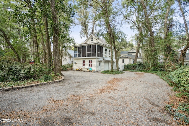 view of front of property with driveway and a sunroom