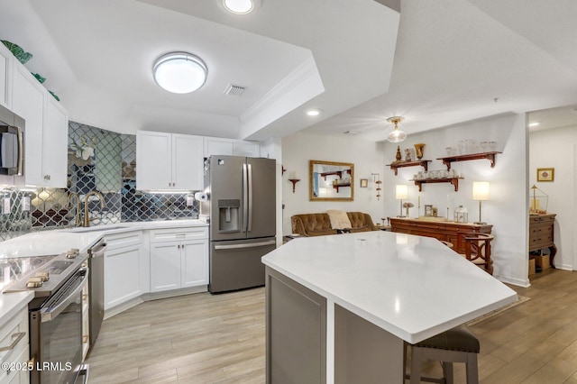 380 Marshland Rd Unit H34, Hilton Head Island, SC 29926 - kitchen with appliances with stainless steel finishes, a sink, light countertops, and light wood-style flooring