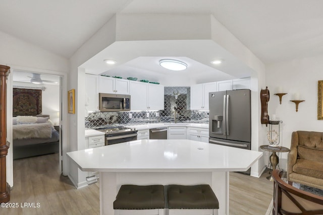 380 Marshland Rd Unit H34, Hilton Head Island, SC 29926 - kitchen featuring light wood finished floors, stainless steel appliances, a sink, backsplash, and light countertops