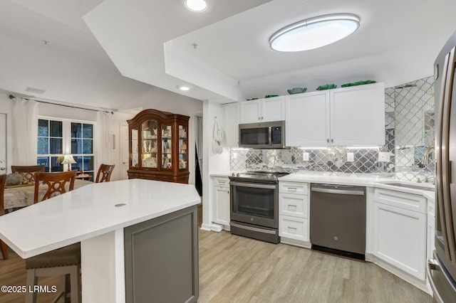 380 Marshland Rd Unit H34, Hilton Head Island, SC 29926 - kitchen with light wood-type flooring, stainless steel appliances, light countertops, and tasteful backsplash