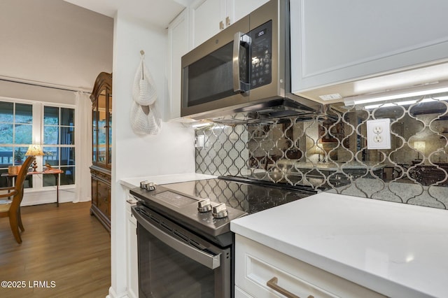 380 Marshland Rd Unit H34, Hilton Head Island, SC 29926 - kitchen with electric range, stainless steel microwave, backsplash, and white cabinets