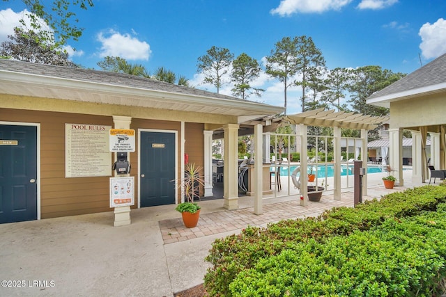 380 Marshland Rd Unit H34, Hilton Head Island, SC 29926 - property entrance with a community pool, a pergola, and a shingled roof