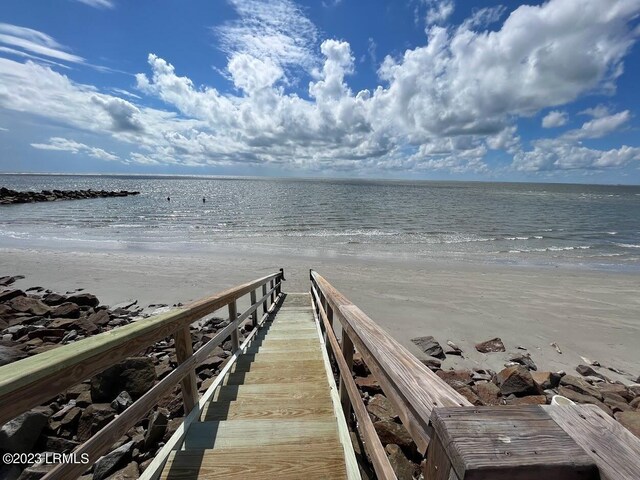 view of dock with a water view and a view of the beach