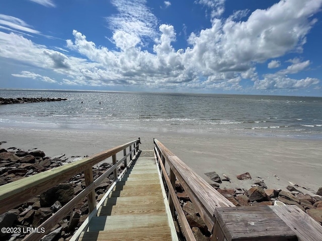 view of dock with a view of the beach and a water view