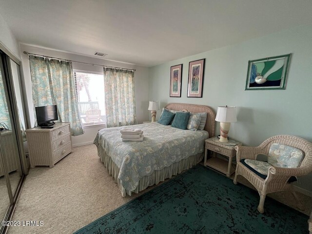 bedroom featuring radiator heating unit and light carpet