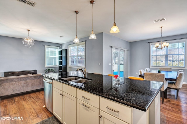 kitchen with a notable chandelier, visible vents, open floor plan, and a sink