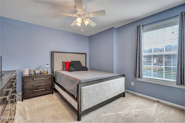 bedroom with light carpet, a ceiling fan, and baseboards