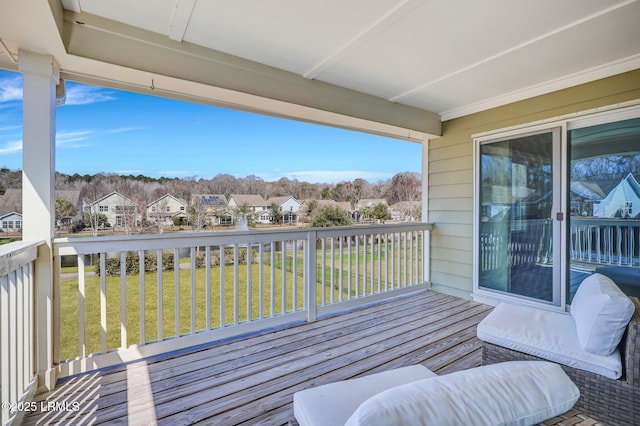 wooden terrace featuring a residential view and a yard