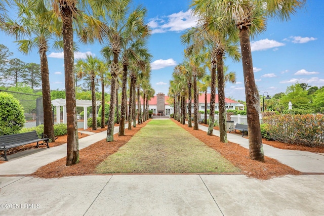 view of community with a yard and fence