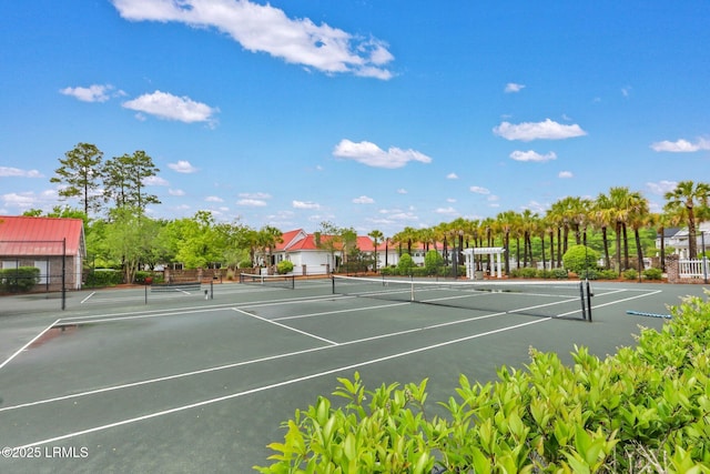 view of sport court featuring fence