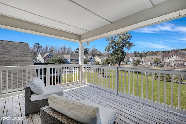 deck with a residential view and a lawn