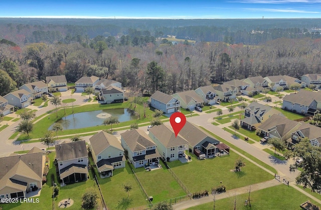 aerial view with a water view, a forest view, and a residential view