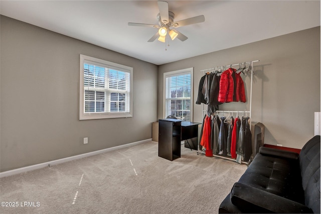 interior space with carpet, baseboards, and ceiling fan