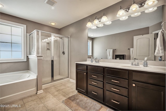 full bath featuring a garden tub, tile patterned flooring, visible vents, and a shower stall