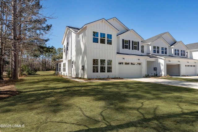 modern farmhouse style home featuring board and batten siding, an attached garage, a front yard, and concrete driveway