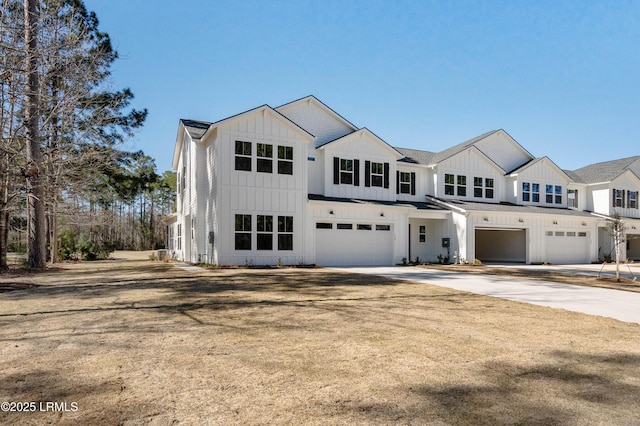 modern farmhouse with board and batten siding, concrete driveway, and a garage