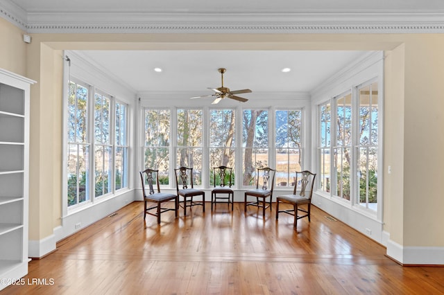 sunroom with visible vents, plenty of natural light, and ceiling fan