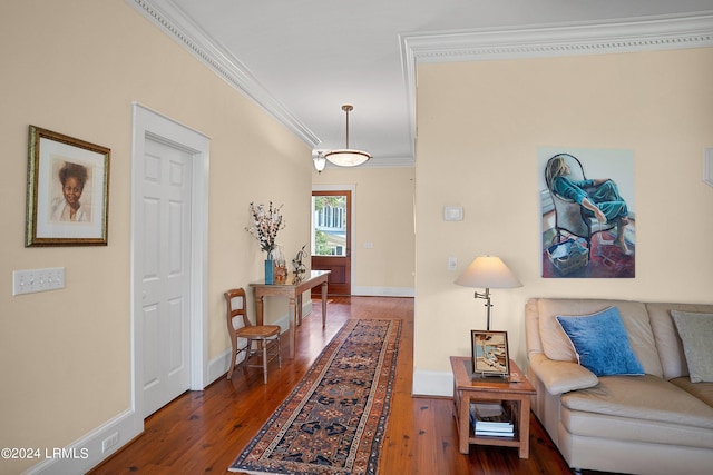 corridor with dark wood finished floors, crown molding, and baseboards