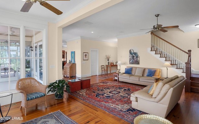 living area featuring crown molding, stairway, ceiling fan, wood finished floors, and baseboards