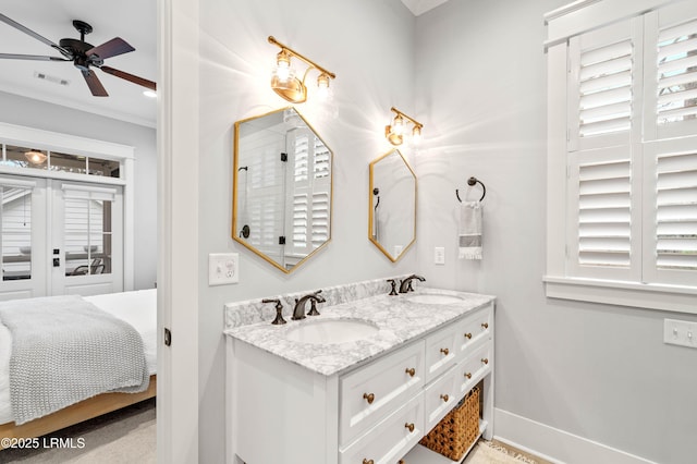 bathroom featuring vanity, ornamental molding, a wealth of natural light, and ceiling fan