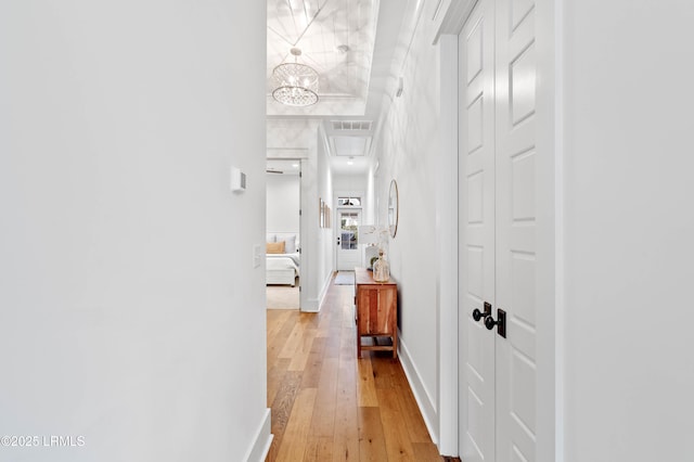 hallway with hardwood / wood-style flooring and crown molding