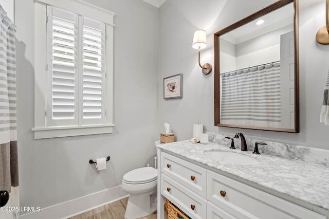 bathroom with hardwood / wood-style flooring, vanity, curtained shower, and toilet