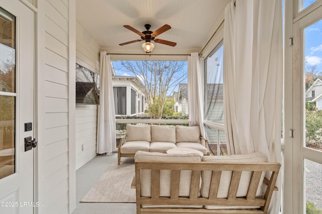 sunroom featuring ceiling fan and a healthy amount of sunlight