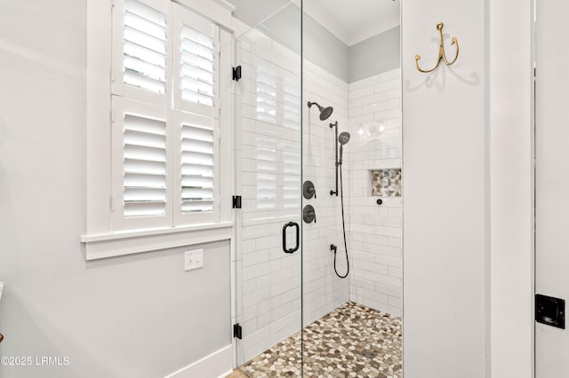 bathroom featuring a shower with door