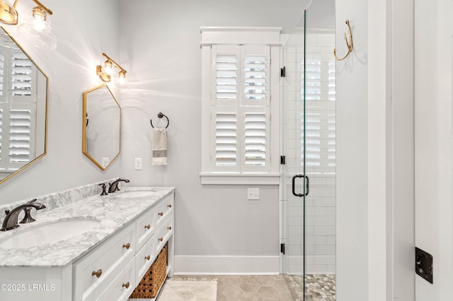 bathroom with walk in shower, vanity, and tile patterned flooring