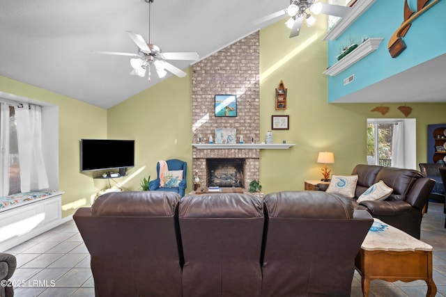 living room with tile patterned floors, visible vents, a brick fireplace, high vaulted ceiling, and ceiling fan