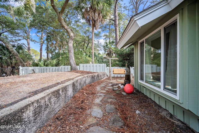 view of side of property with fence and mail area