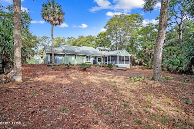 back of property with a sunroom