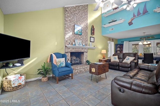 tiled living room with a towering ceiling, visible vents, baseboards, a fireplace, and ceiling fan