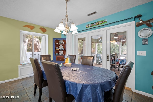 dining space featuring visible vents, baseboards, a notable chandelier, and french doors